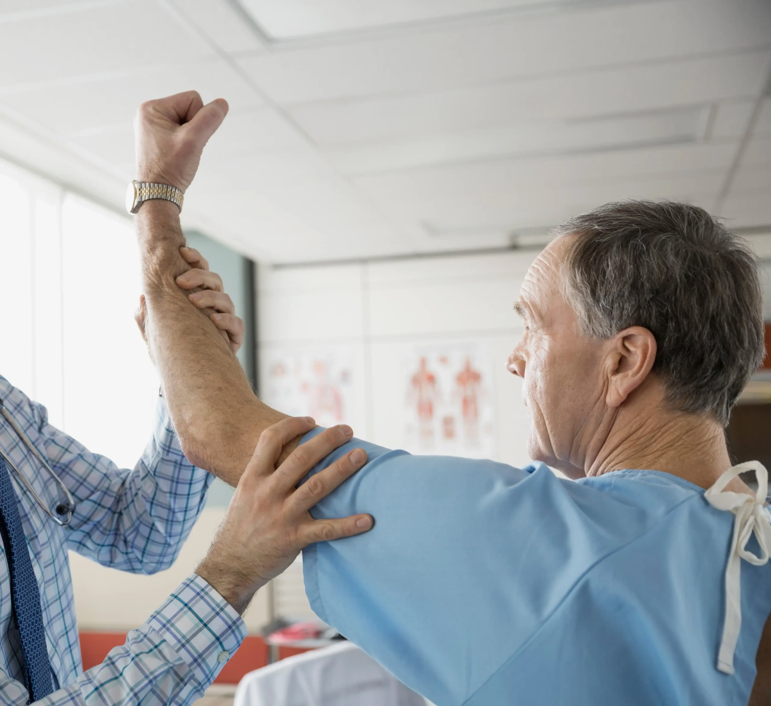 Doctor performing clinical shoulder examination for frozen shoulder assessment