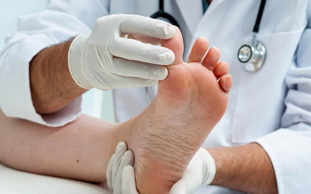 Doctor examining a patient during a diabetic foot care assessment in Kuala Lumpur